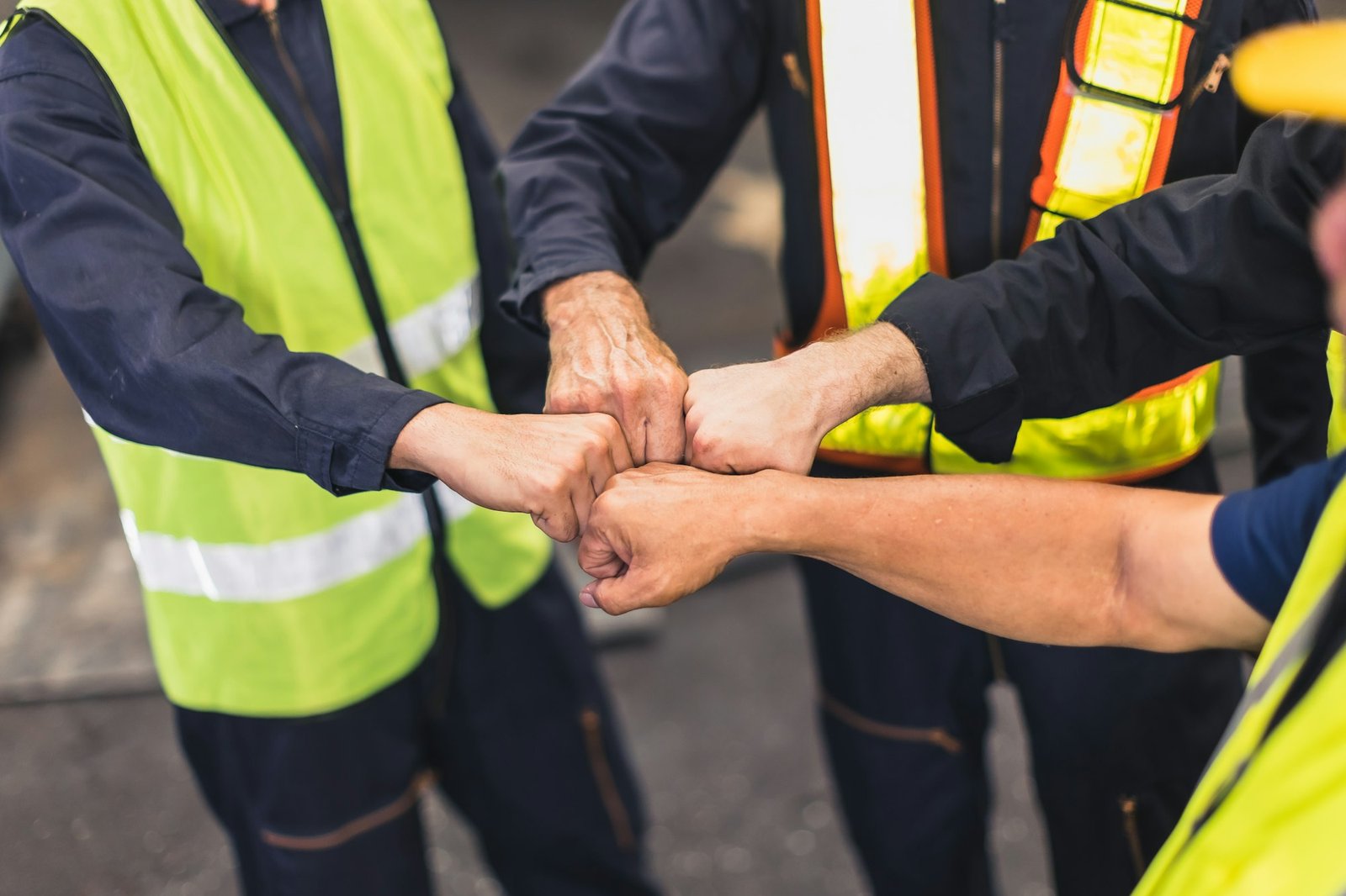 Engineer team worker builder hand bumping together for strong teamwork cooperative workforce